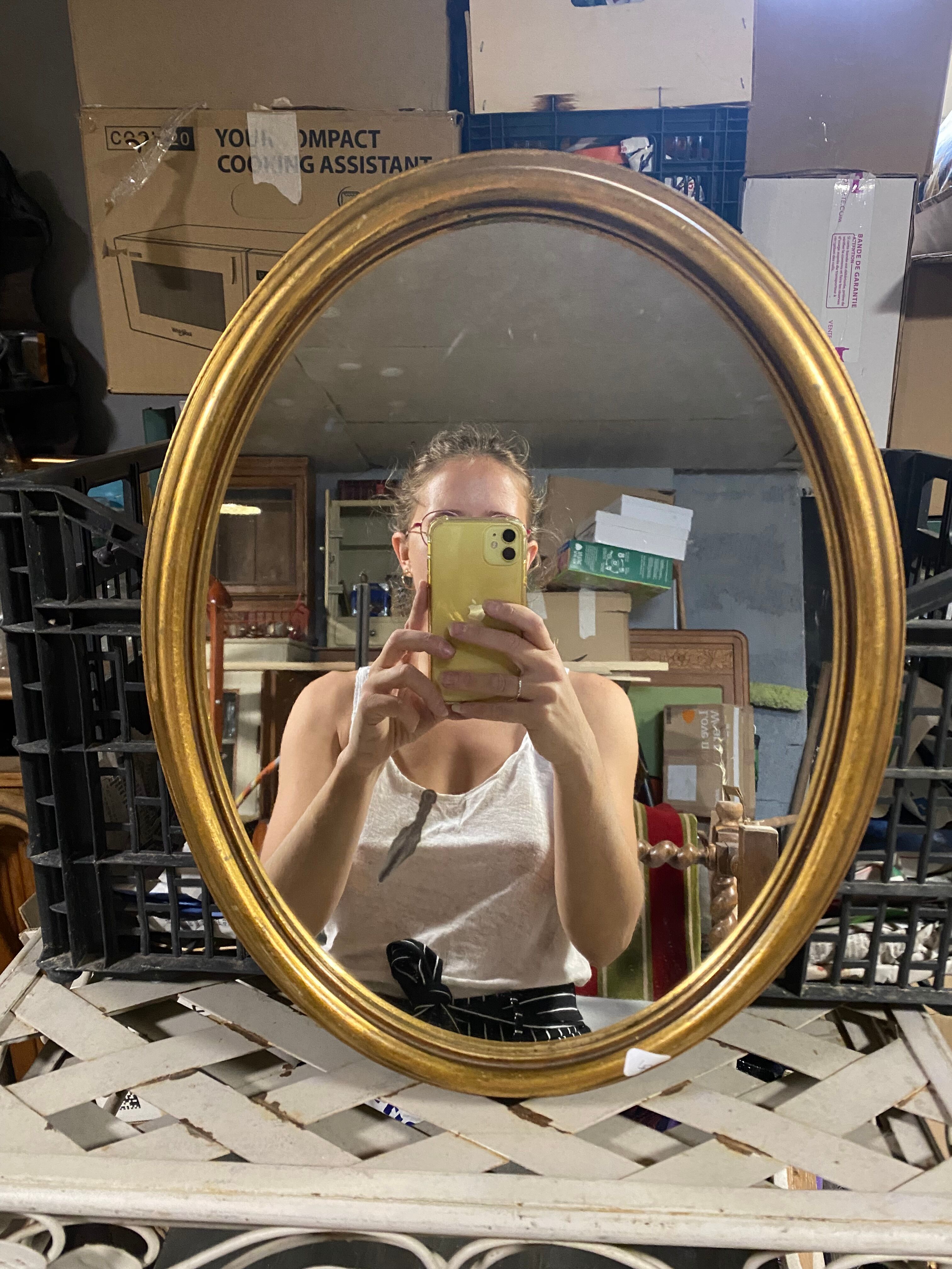 Golden oval mirror