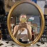 Golden oval mirror