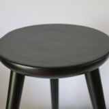 Black tripod wooden stool
