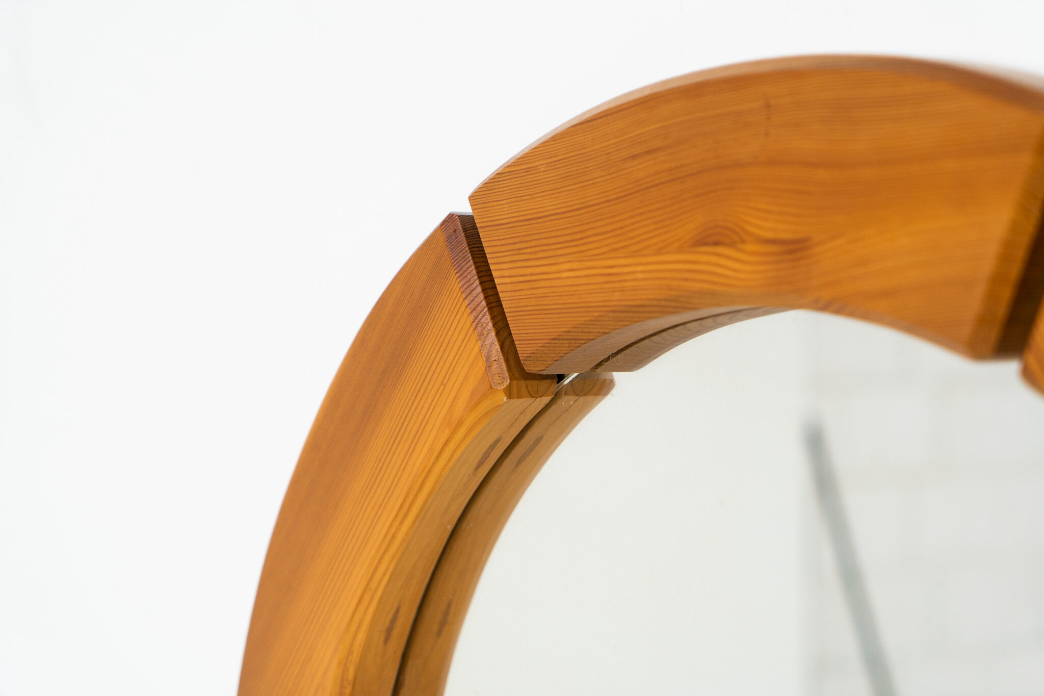 Sculptural wall mirror in solid pine