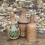 Glass bottles and rattan, woven wicker