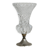 Small vase on a metal stand with thick glass.