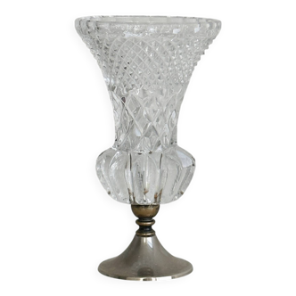 Small vase on a metal stand with thick glass.