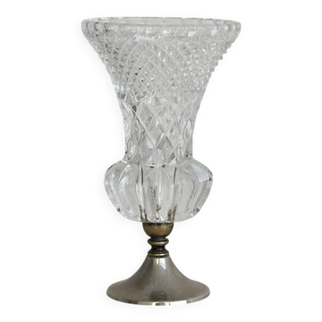 Small vase on a metal stand with thick glass.