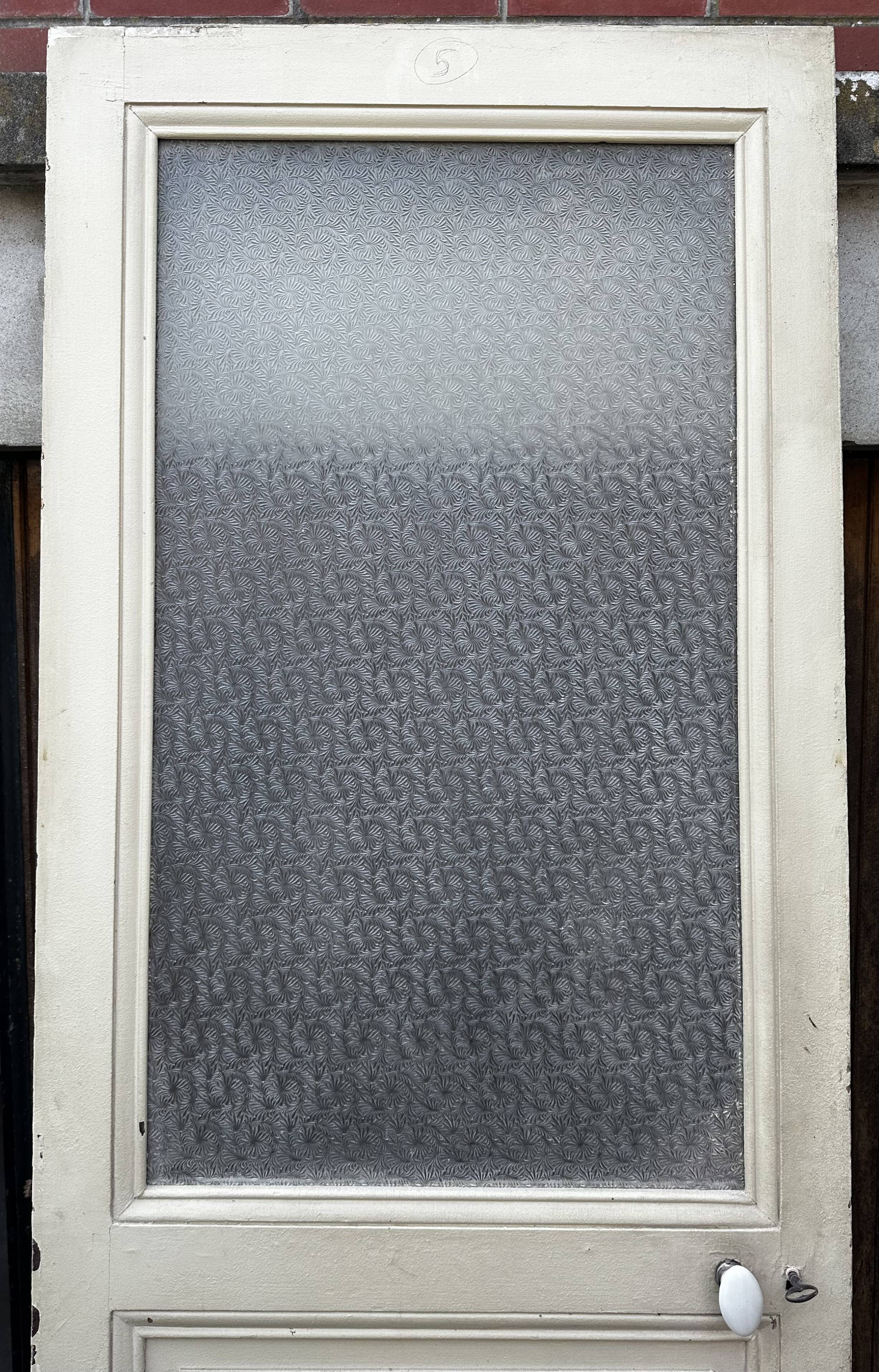 Old door from 1890 in solid wood with translucent glass at the top