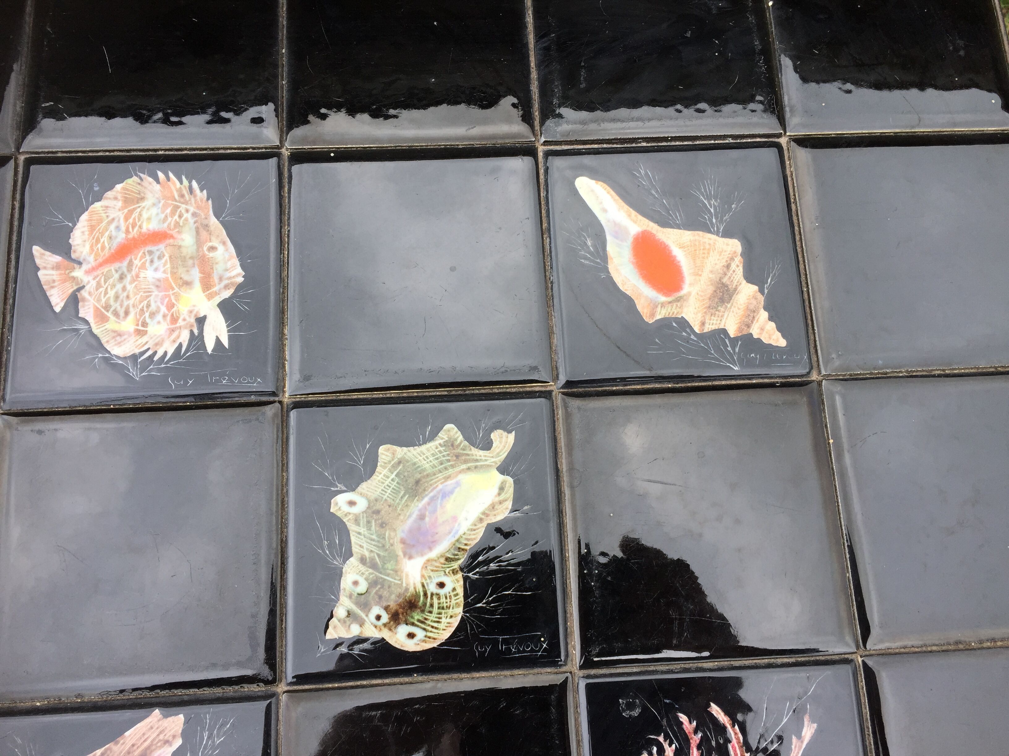 Vintage ceramic coffee table by Guy Trévoux with wrought iron base.