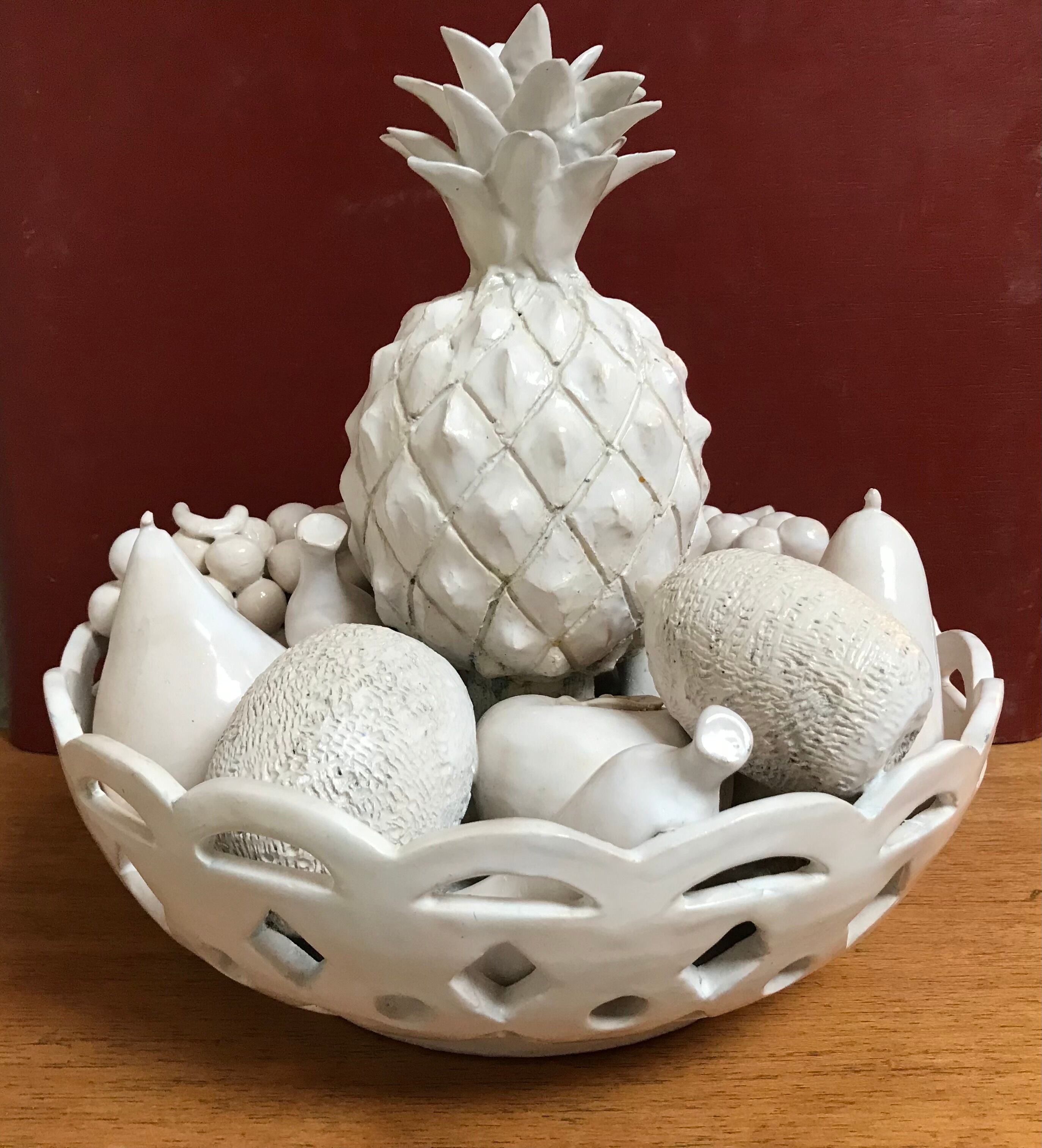 Trompe l'oeil fruit cut in white earthenware by Jean Roger, circa 1960.