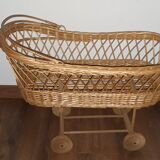 Vintage wicker cradle with wheels