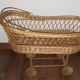 Vintage wicker cradle with wheels