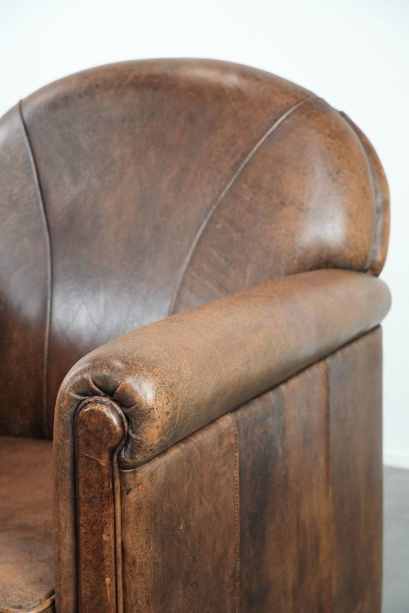 Vintage sheepskin armchair with warm colours and a characterful appearance