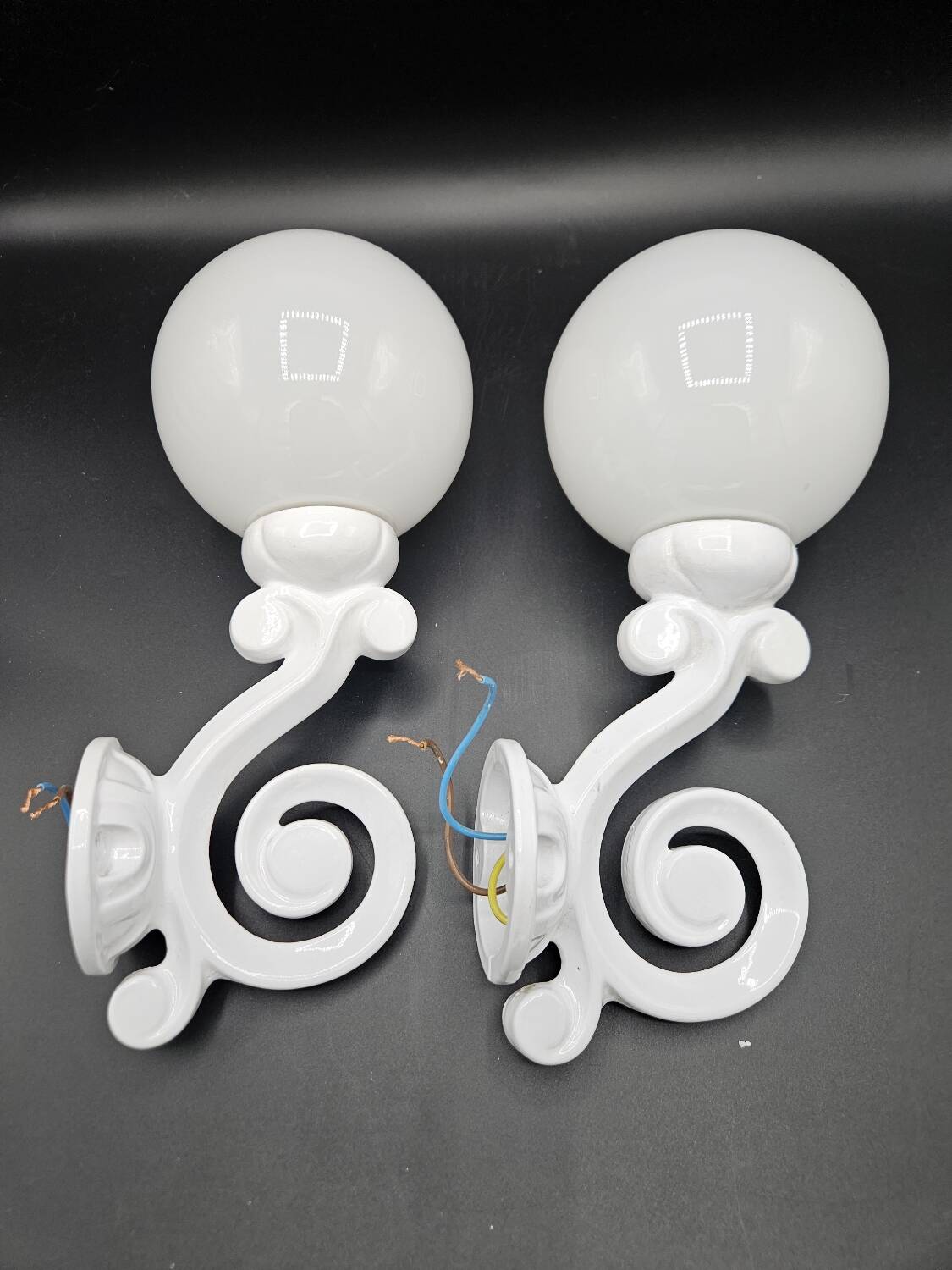 Pair of white enameled cast iron wall sconces, mid-20th century
