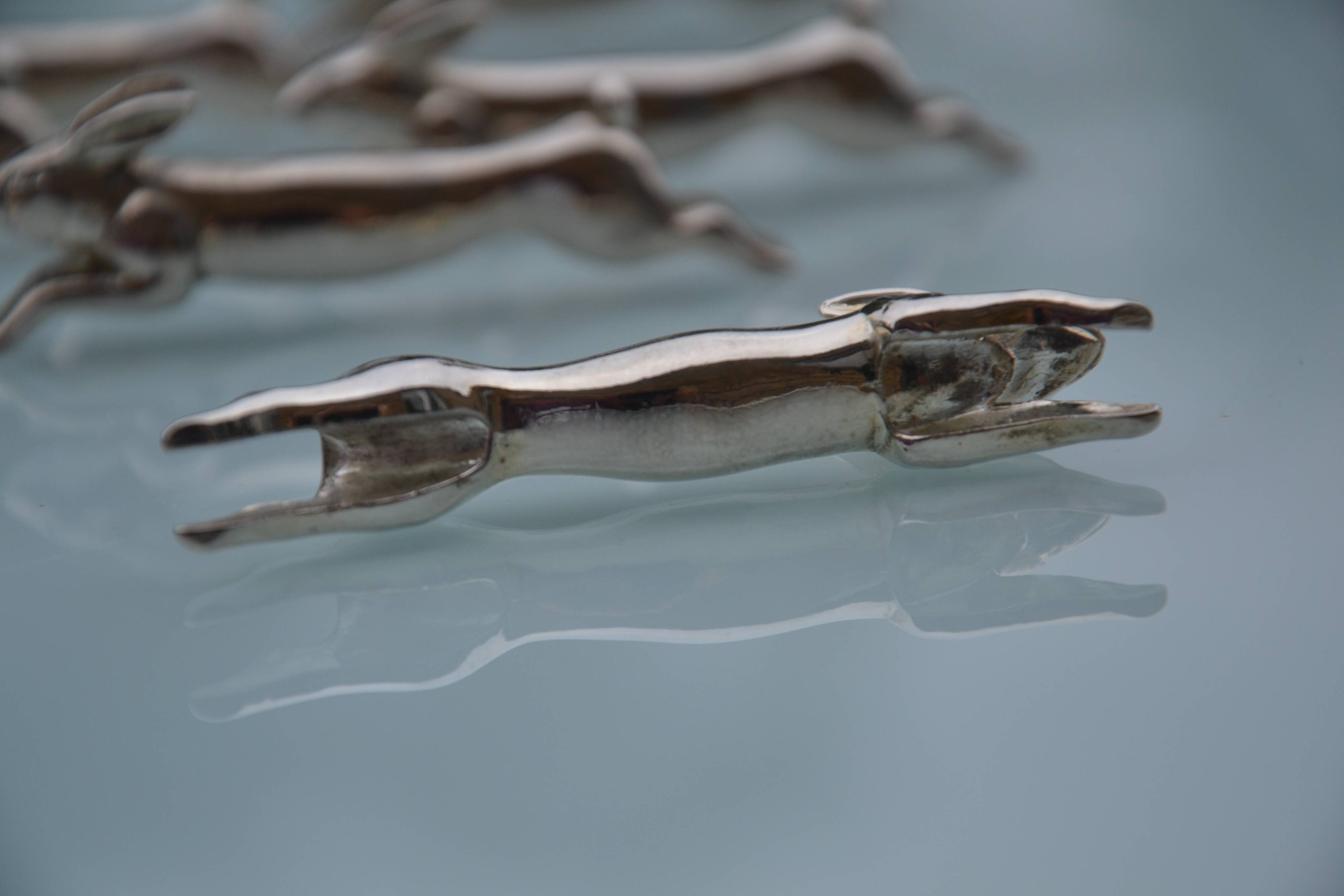 12 silver-plated metal "rabbit" knife rests