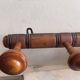 Wall-mounted coat rack with 8 turned wooden hooks in faux bamboo style.
