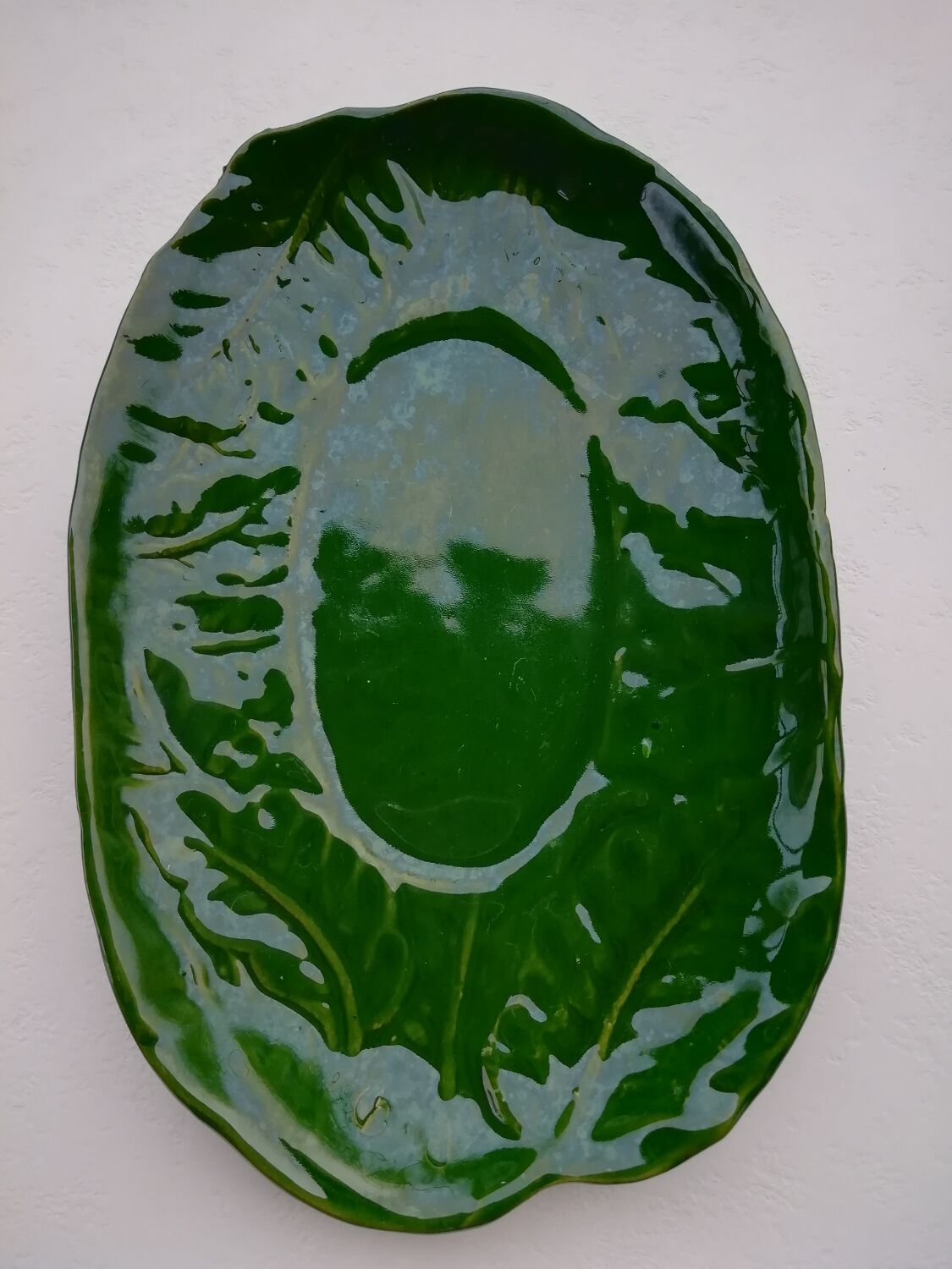 Oval flat decoration in relief