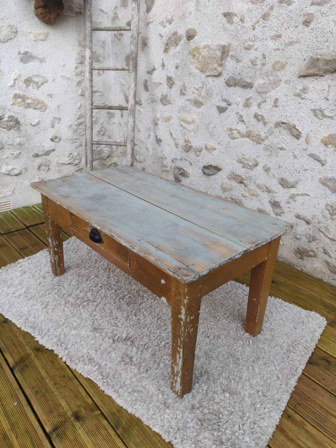 Patinated coffee table with a drawer