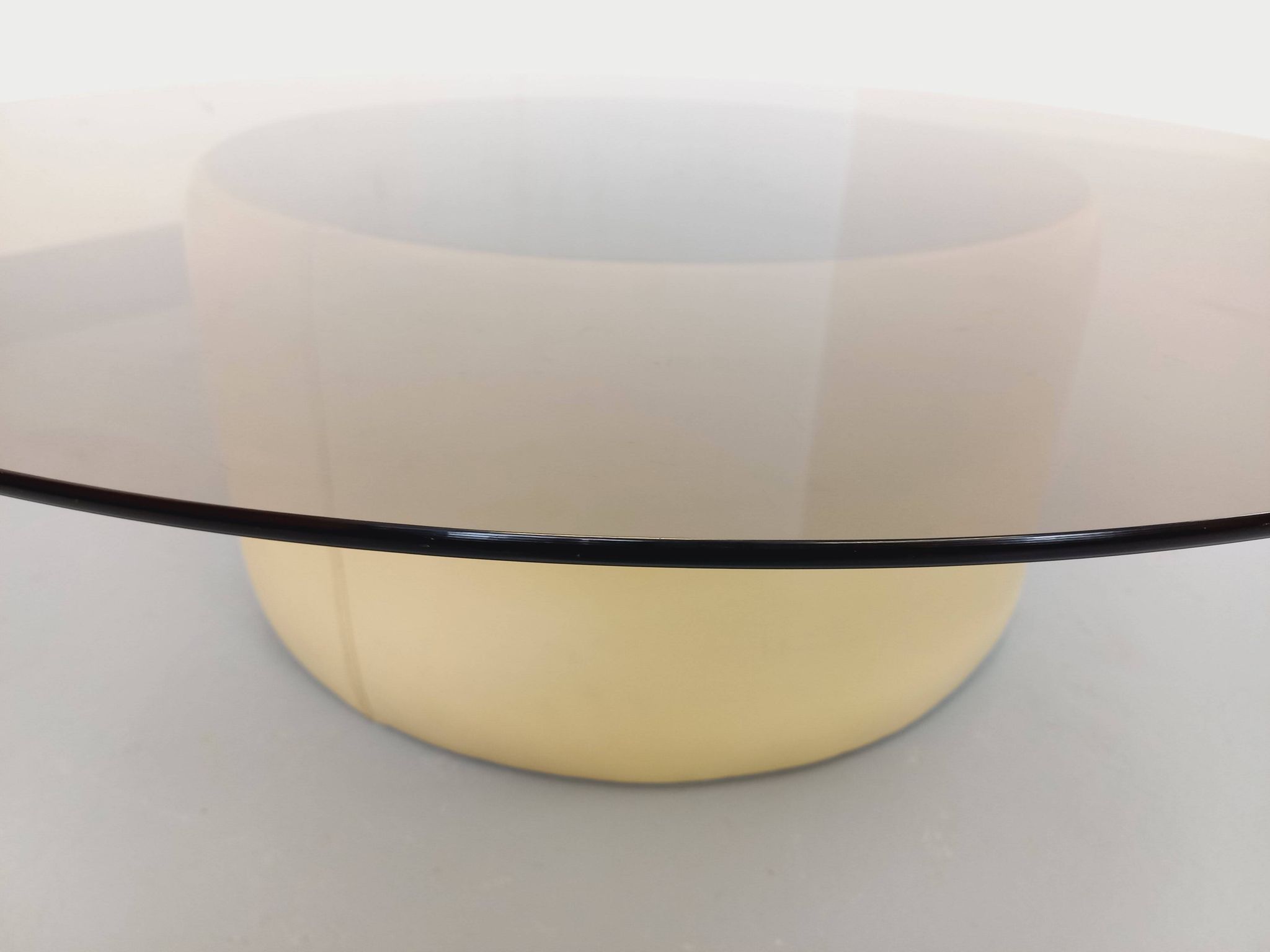 Vintage round coffee table in glass, leather, and metal in Space Age style from the 70s.
