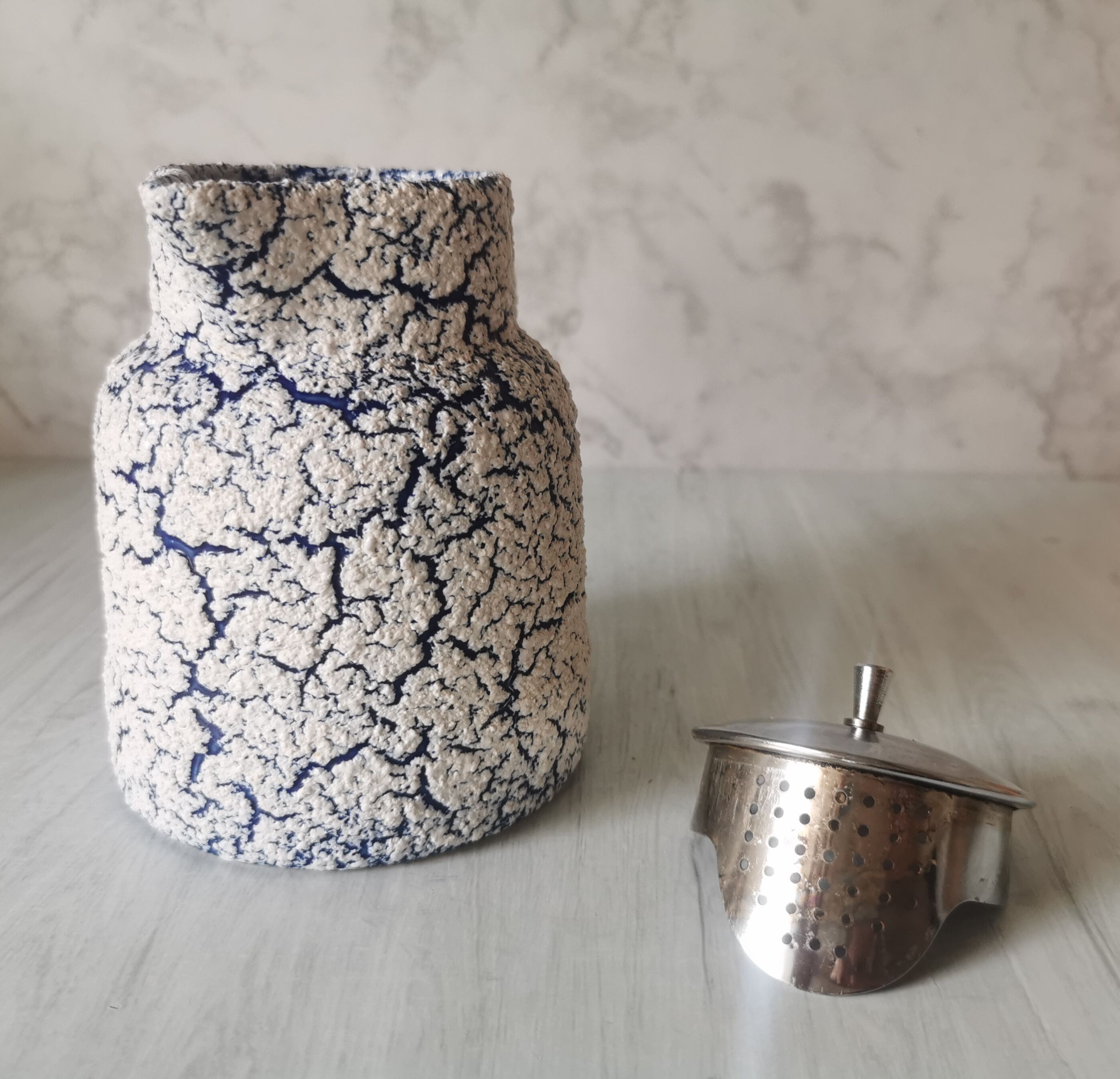 Cracked and enamelled ceramic teapot