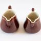 Duo of brown enamel pitchers