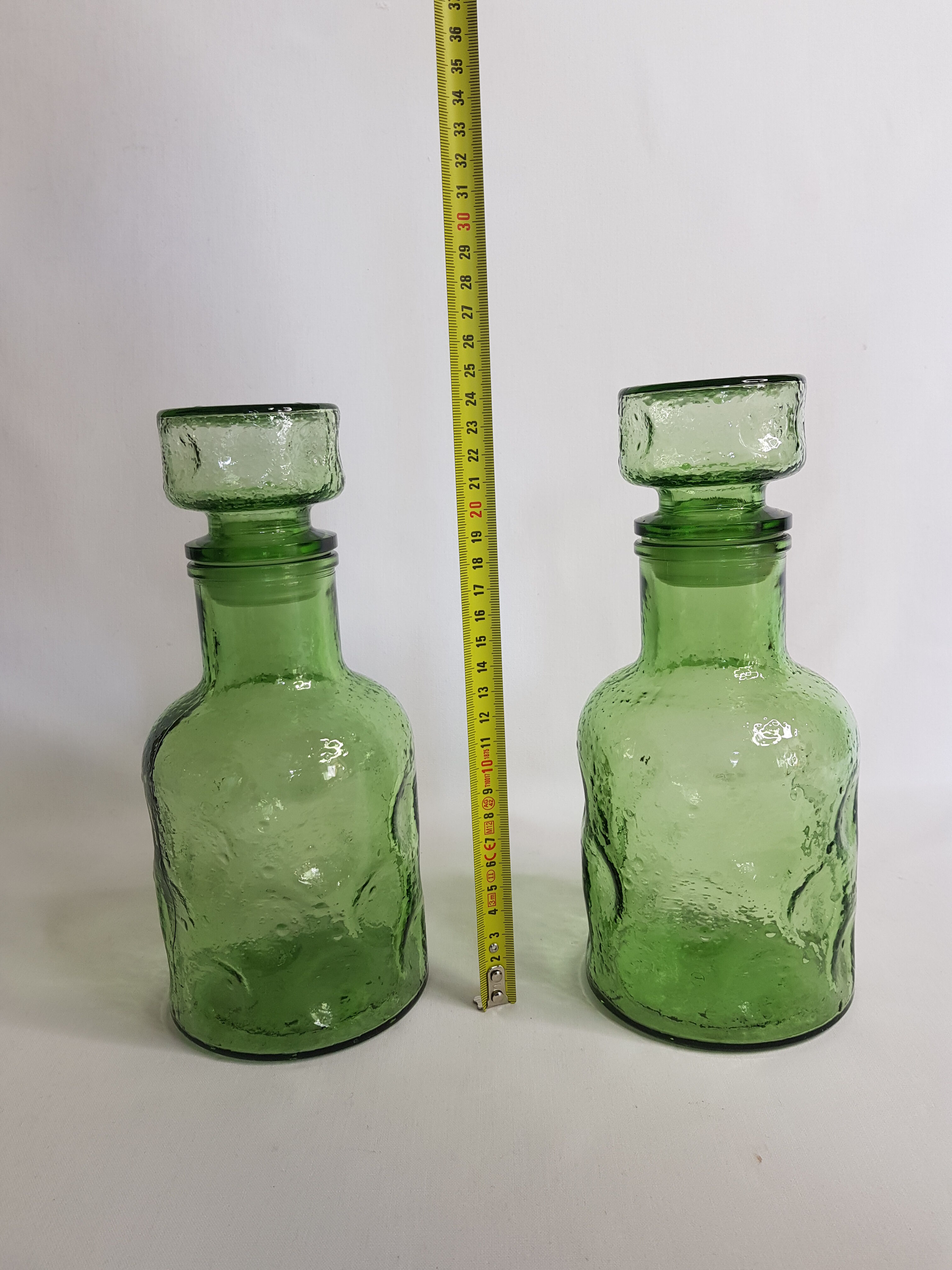 Pair of green moulded glass bottles 70s