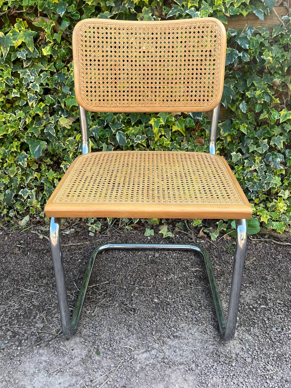 Wooden chair with caning in the style of Marcel Breuer.