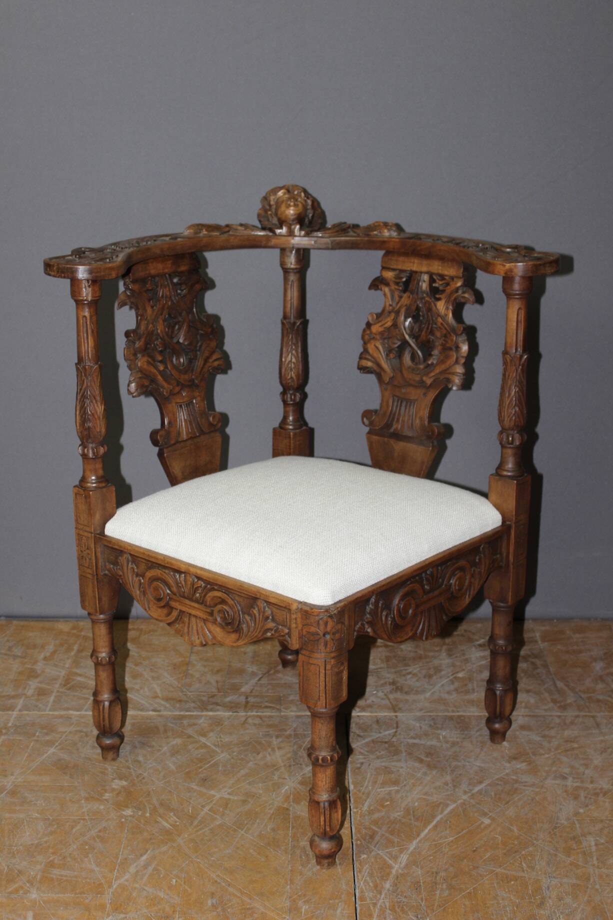 19th century walnut corner armchair with carved angel decoration