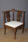 19th century walnut corner armchair with carved angel decoration