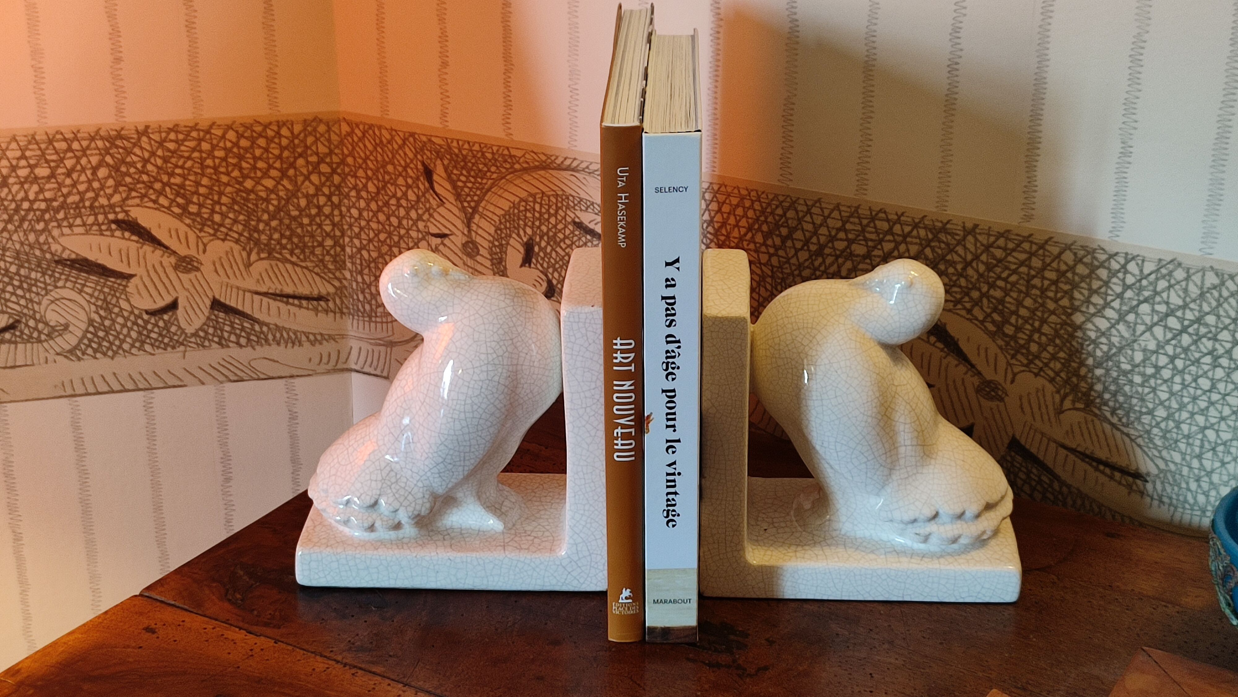 Pair of greenhouse art-deco books about cracked earthenware bird