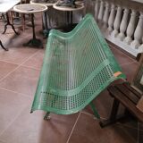 Vintage green perforated metal public bench
