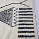 Handmade pure wool rug in black and white, size 150 x 250 cm.