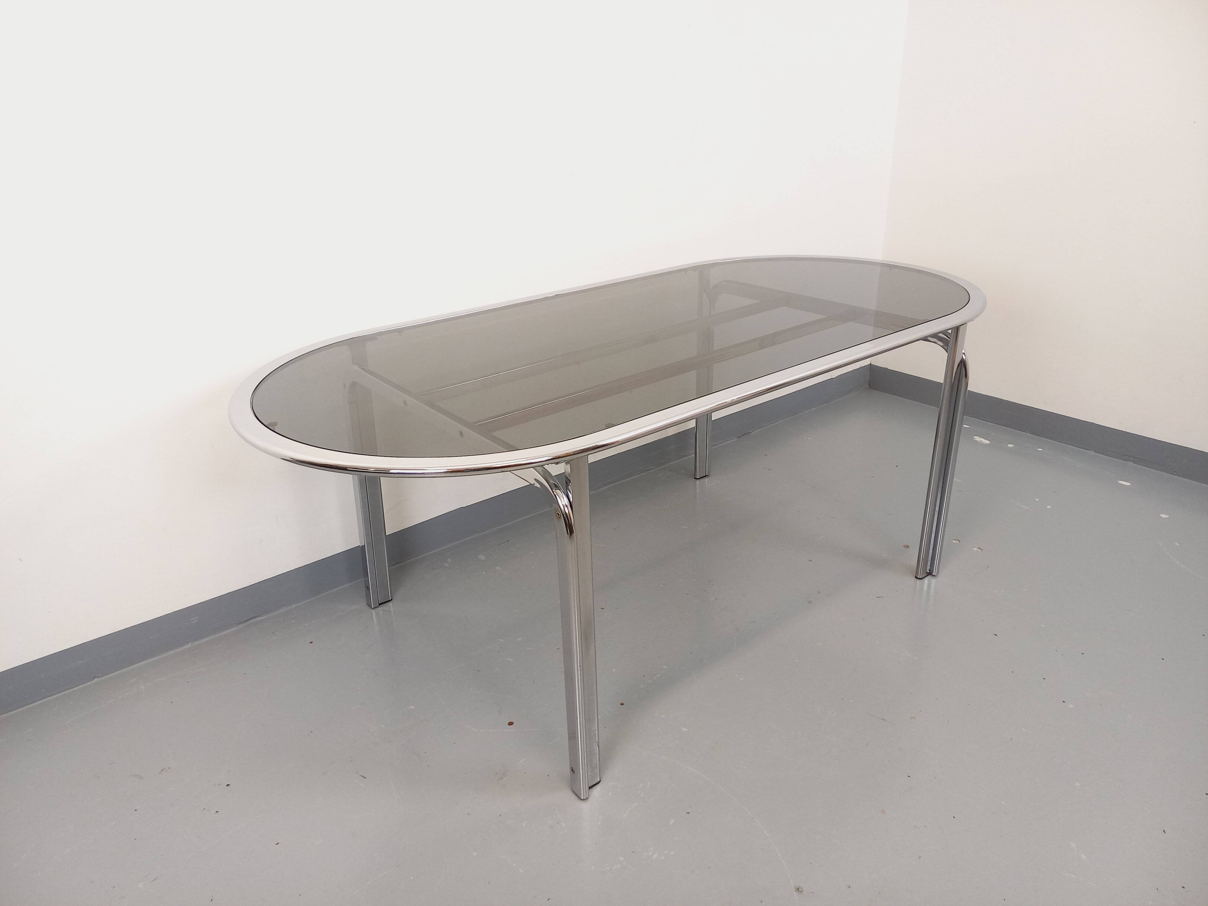 Vintage oval dining table in smoked glass and chrome metal, Space Age style.
