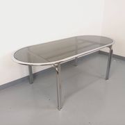 Vintage oval dining table in smoked glass and chrome metal, Space Age style.