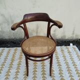 Caned chair with armrests attributed to Fischel