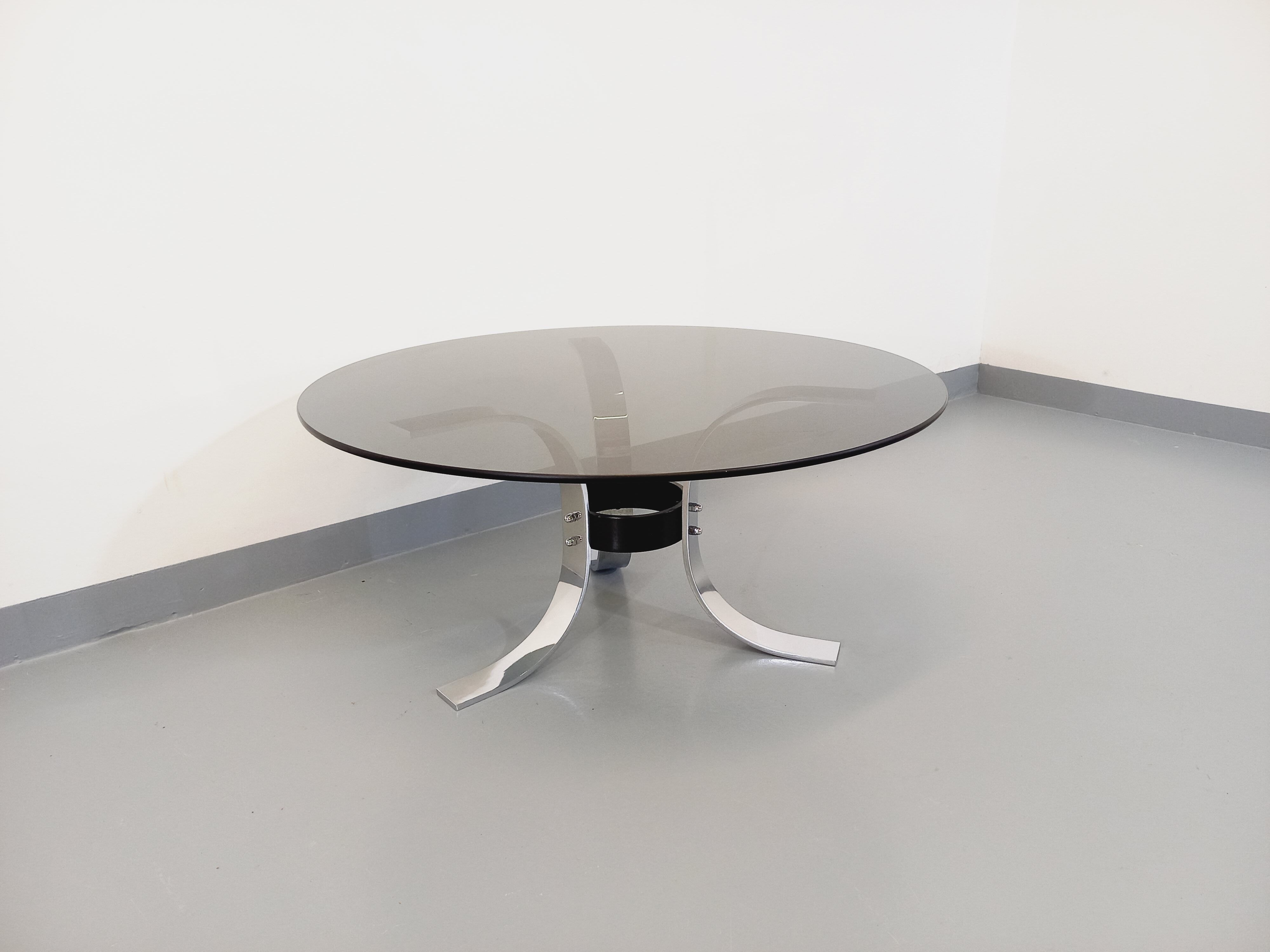 Vintage round coffee table in glass, chromed metal and black metal Space Age style of the 70s