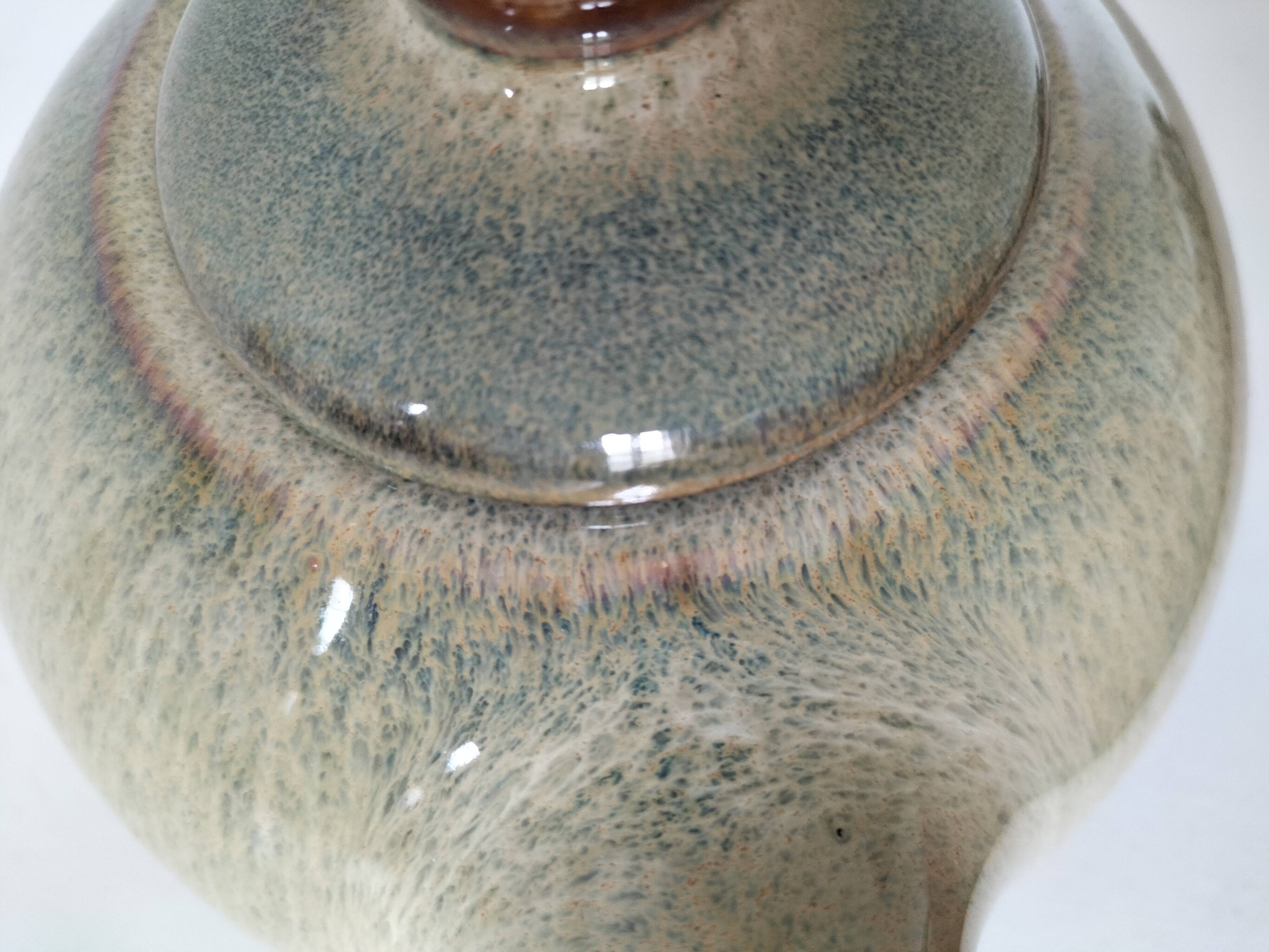 Vintage ceramic teapot with a flame design.