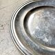 Round silver-plated metal dish monogrammed "MR"