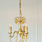 Small vintage brass chandelier with amber crystal pendants.