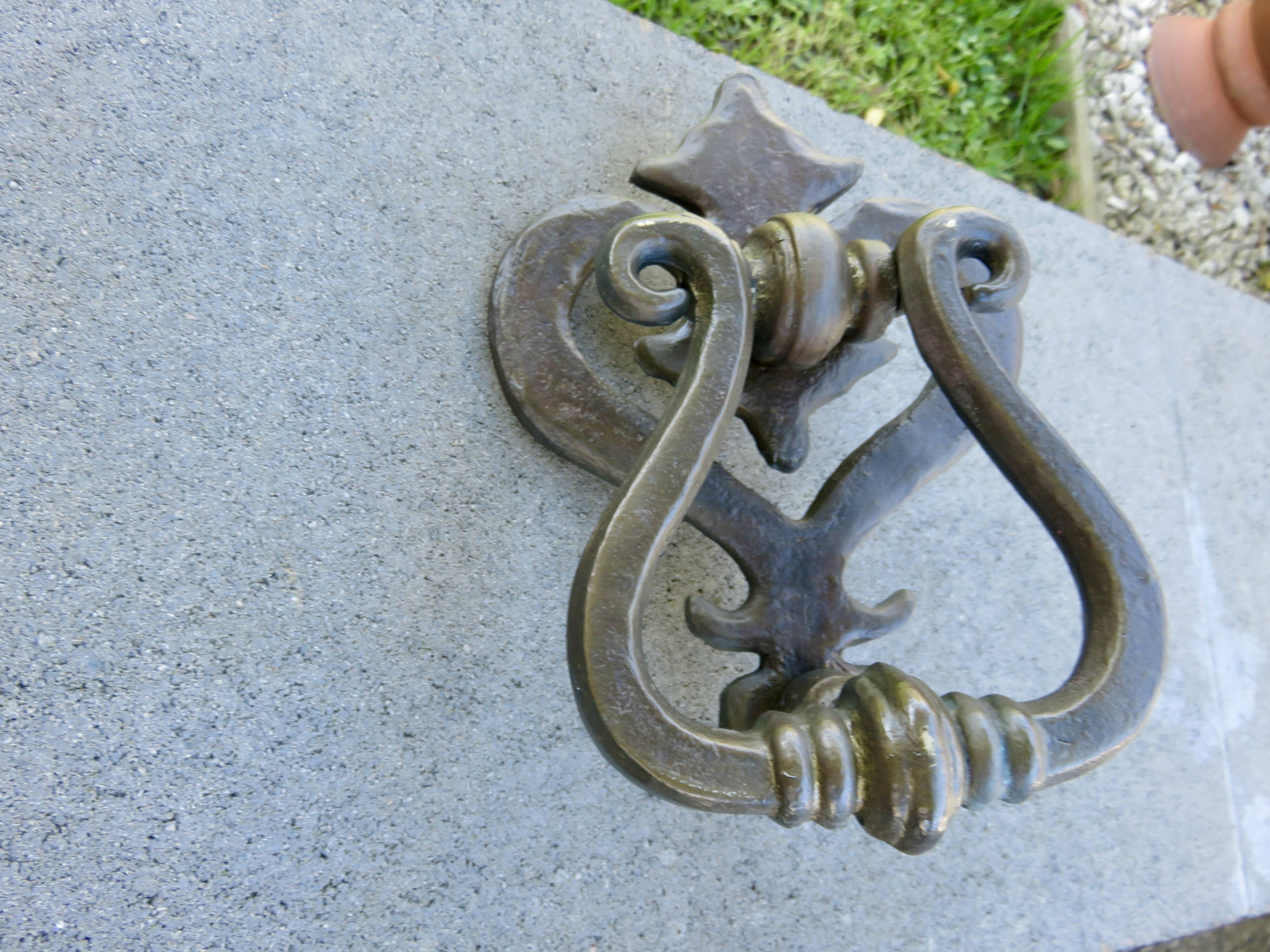 Impressive door knocker from the High Middle Ages in solid bronze.