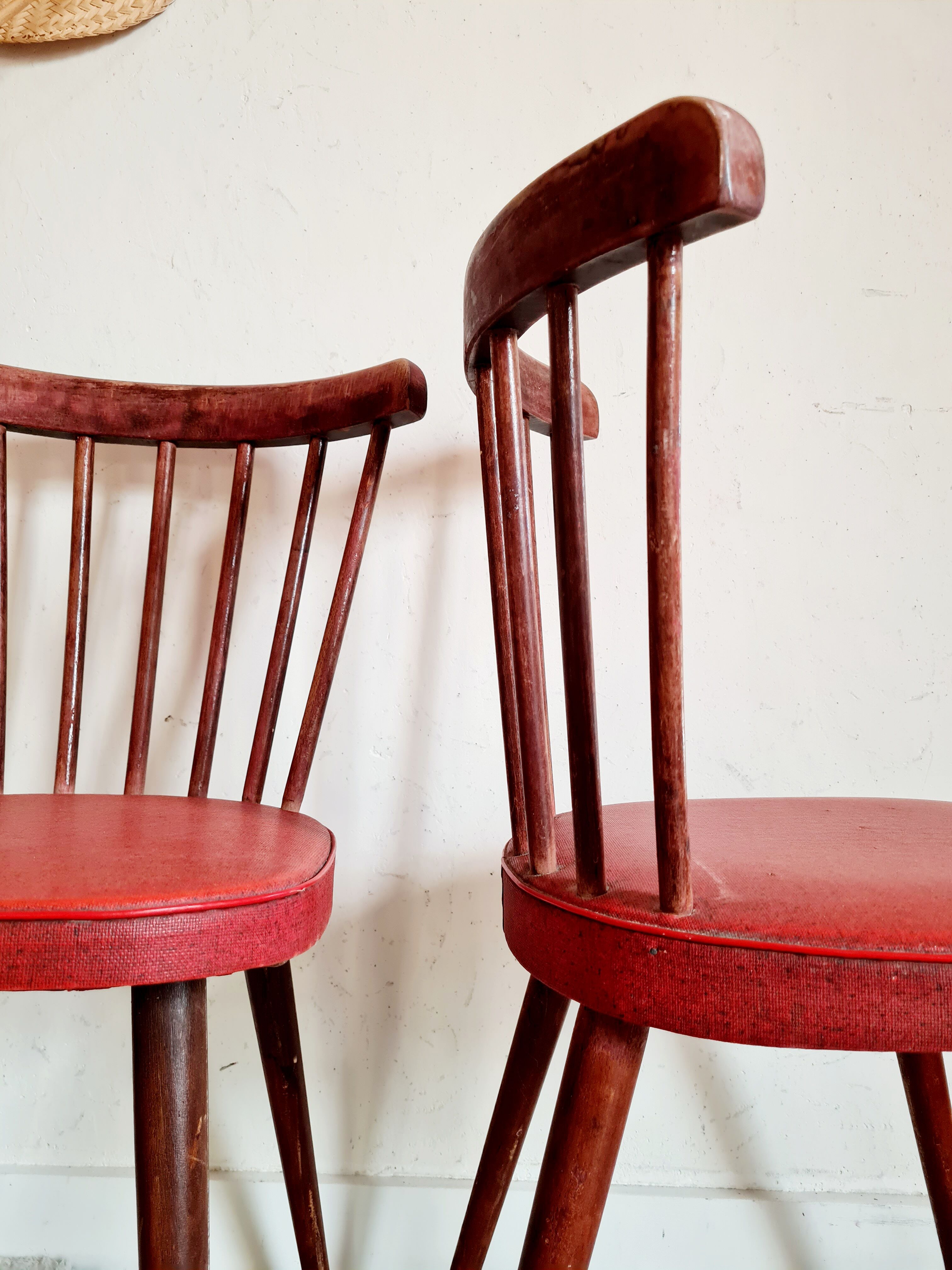 Pair of wooden bistro chairs and red imitation seating