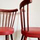 Pair of wooden bistro chairs and red imitation seating