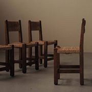 Set of four modernist chairs in oak and straw, France, circa 1960.