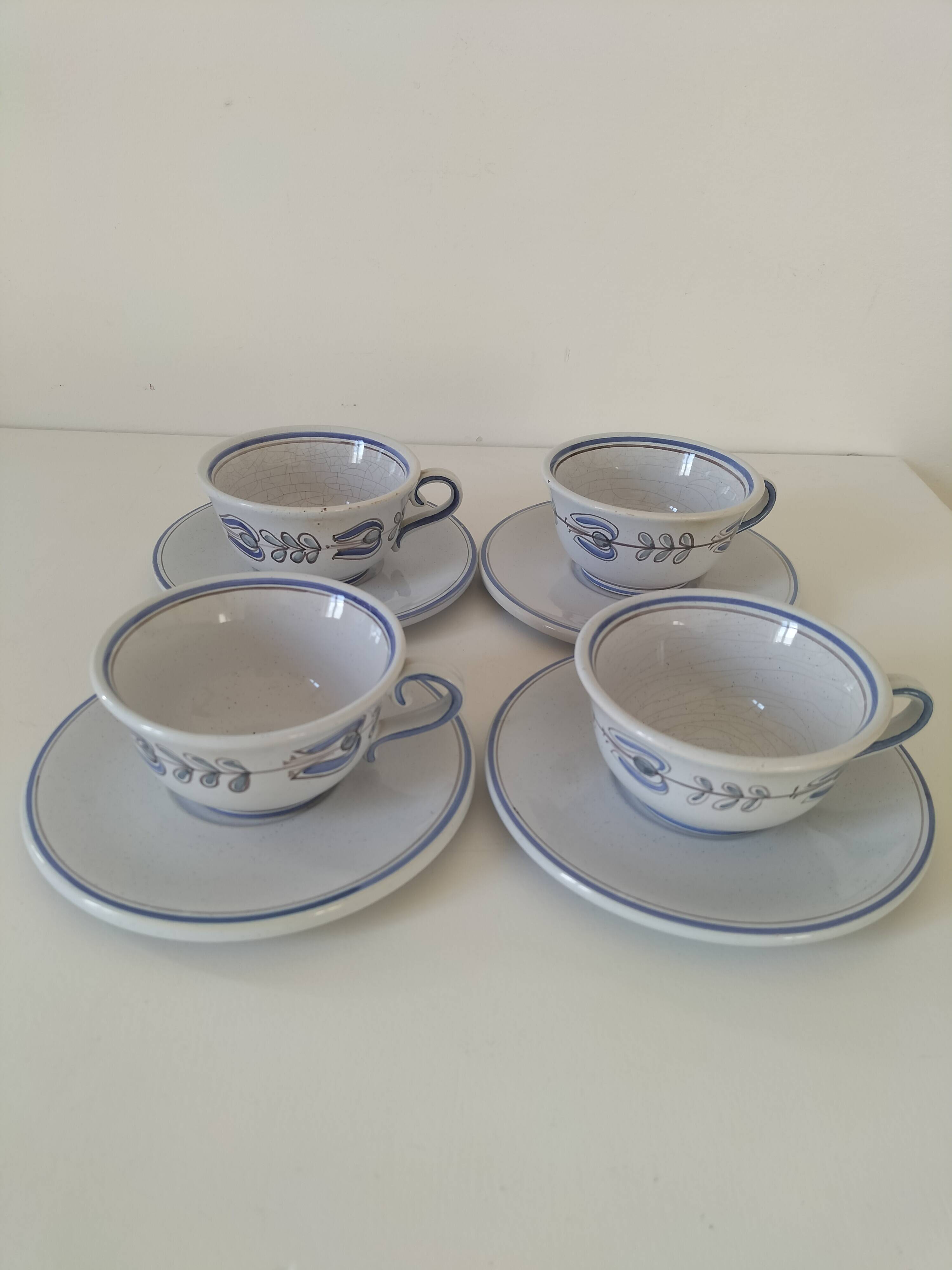 Glazed earthenware cups and saucers