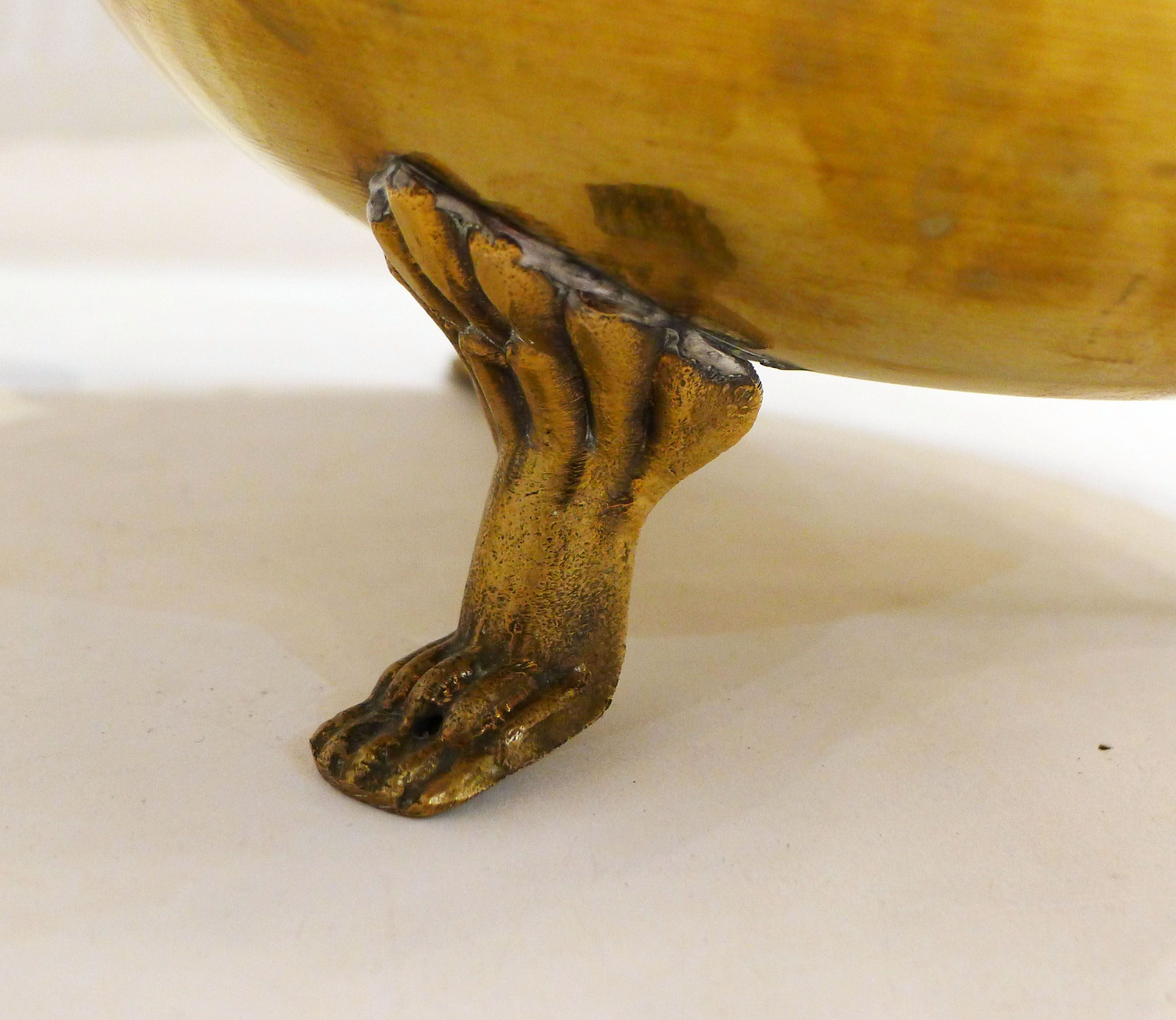 Planter on lion legs, made of golden metal