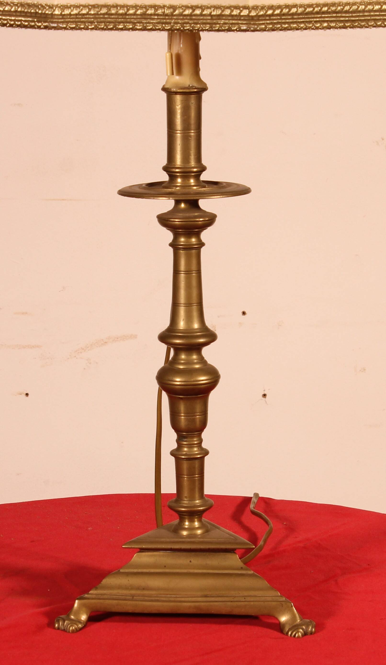 bronze candlestick from the 17th century converted into a lamp with its lampshade