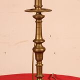 bronze candlestick from the 17th century converted into a lamp with its lampshade