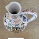 Polychrome earthenware jug, hand-decorated with floral motifs