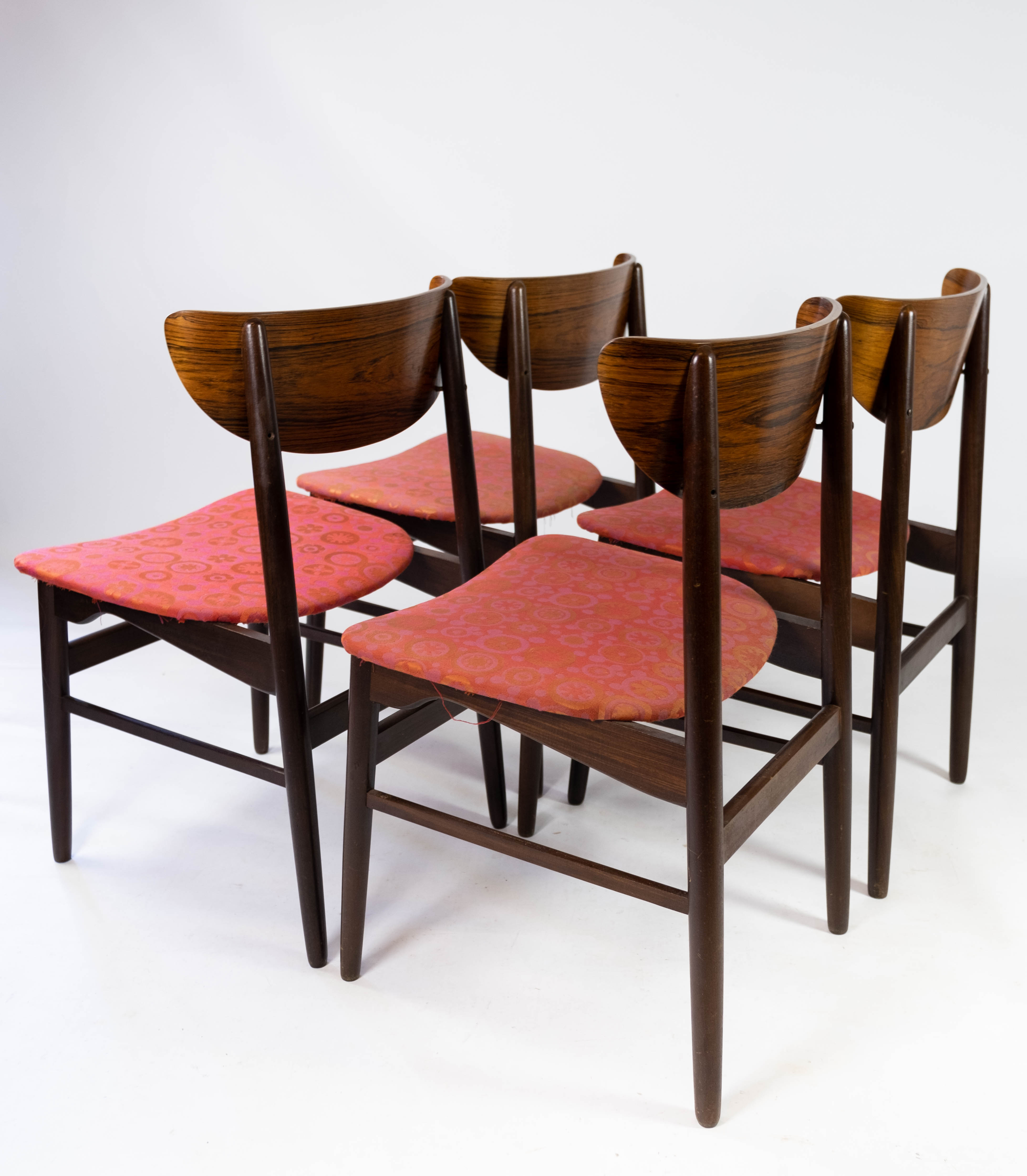 Set of four dining room chairs in rosewood and upholstered with red fabric, of danish design, 1960s