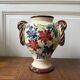Ceramic vase with hand-painted floral decoration.