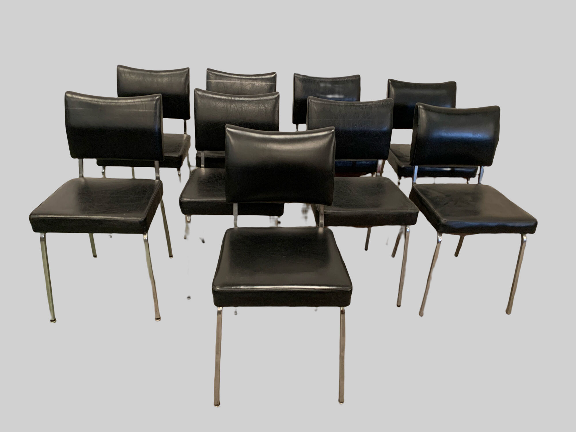 Suite of nine vintage chairs in chrome and imitation leather XX century
