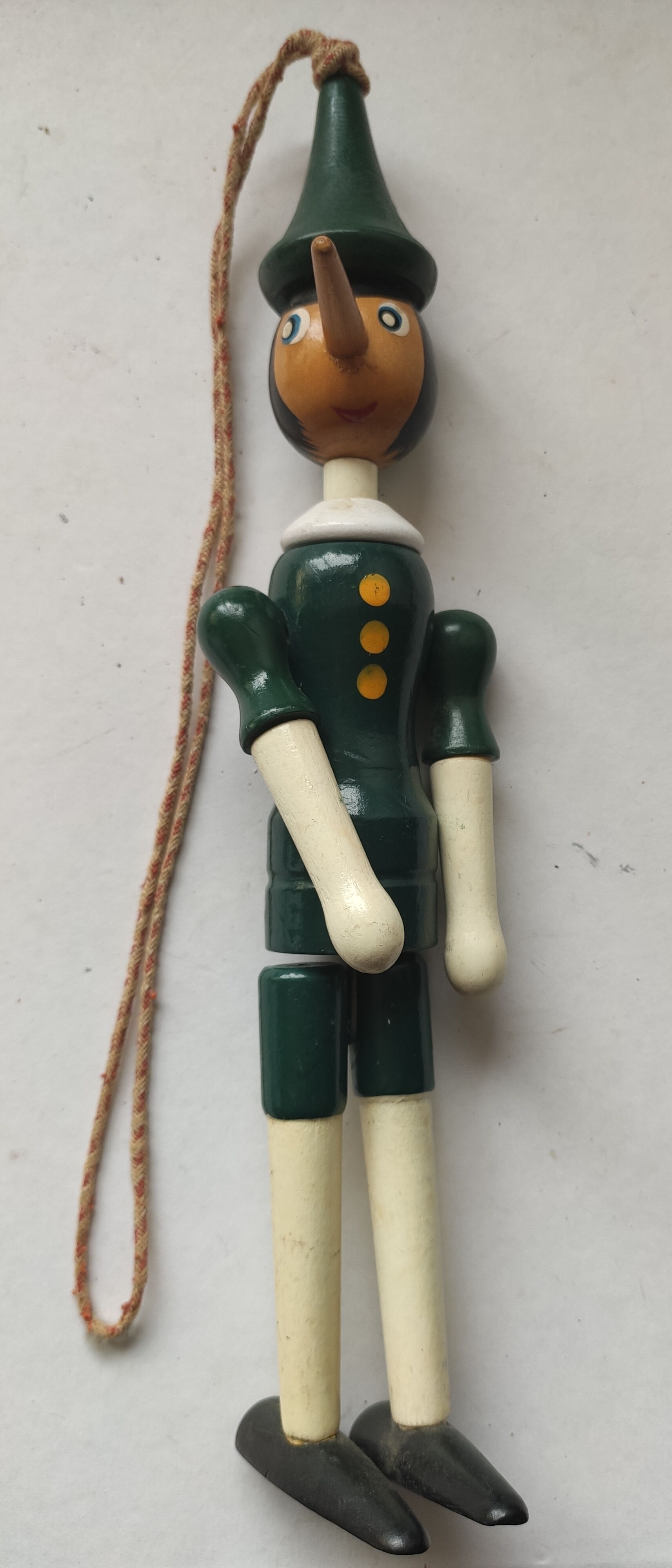 Green pinochio puppet in old wood
