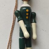 Green pinochio puppet in old wood